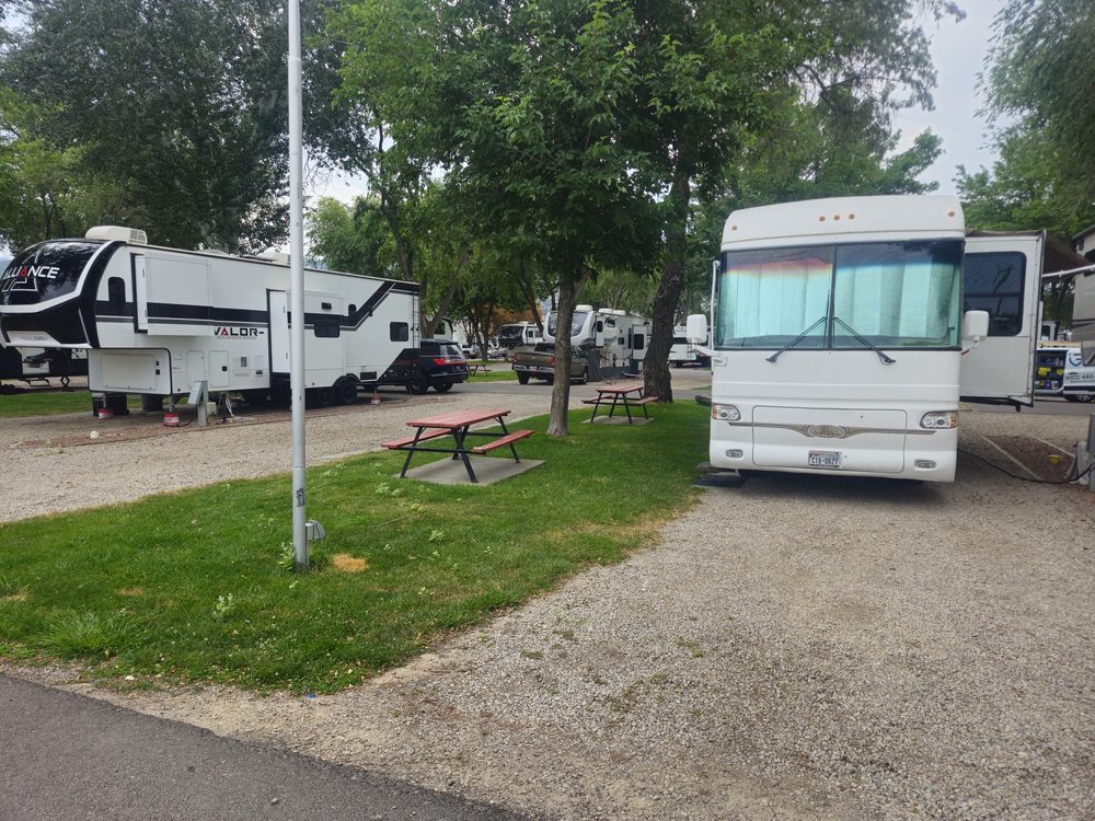 Full-hookup RV site with motorhome, grass and picnic table